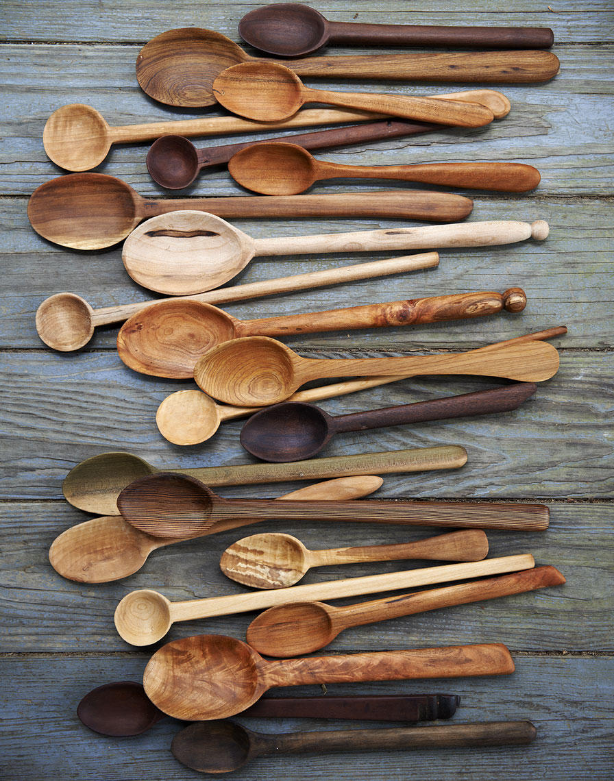 multiple handcarved wooden spoons on wooden background Still-life by Alison Gootee Photography