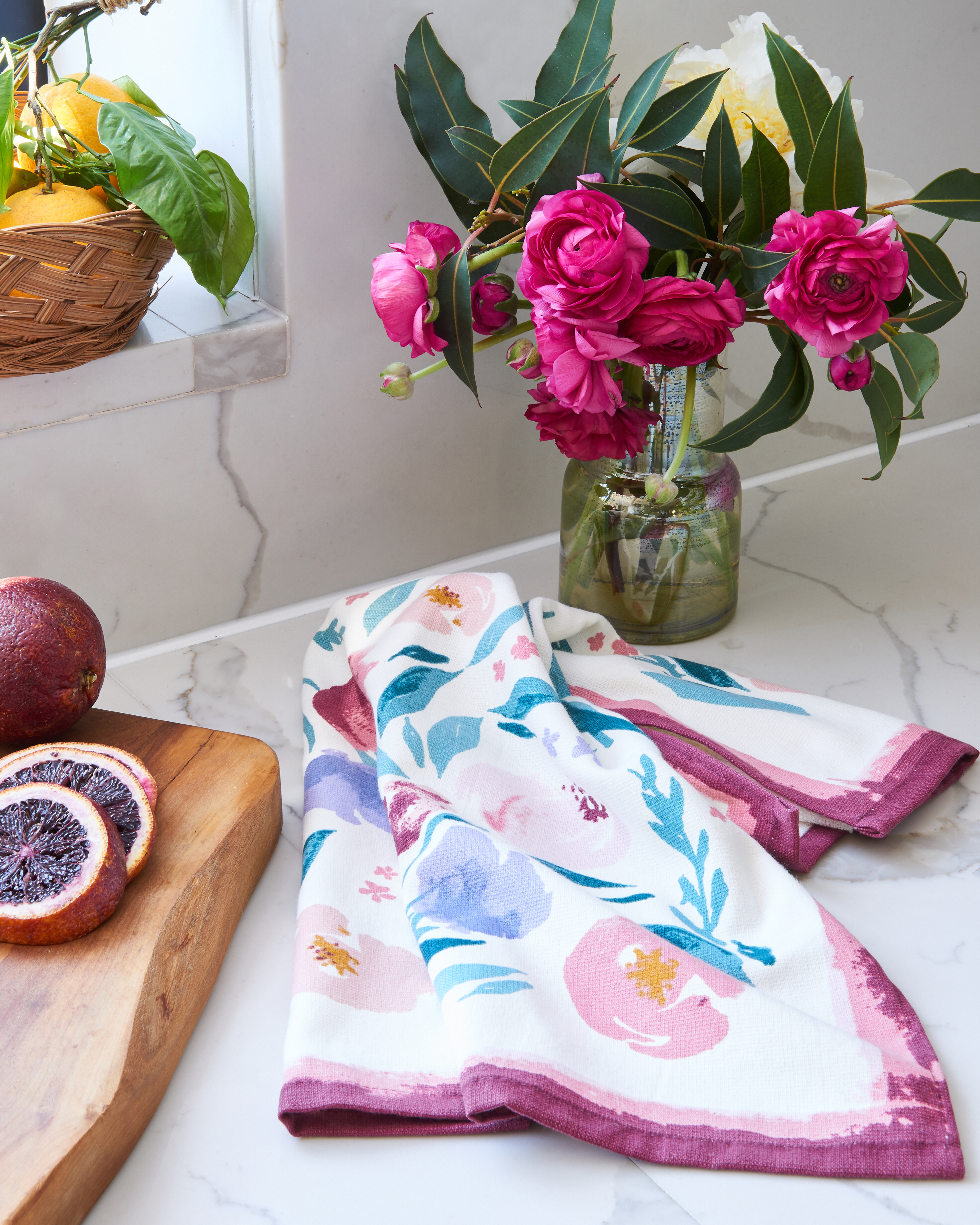 Kitchen towel on kitchen counter with cutting board and flowers Still-life by Alison Gootee Photography