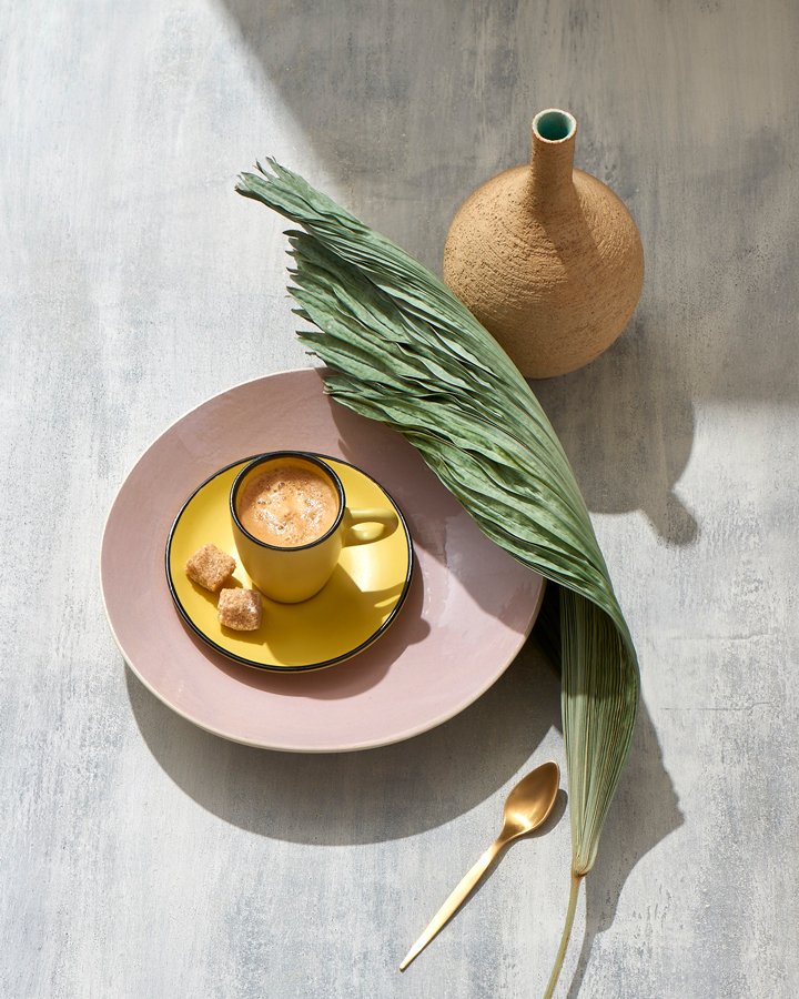 Sunny table-top of espresso cup dried palm small gold spoon  Still-life by Alison Gootee Photography