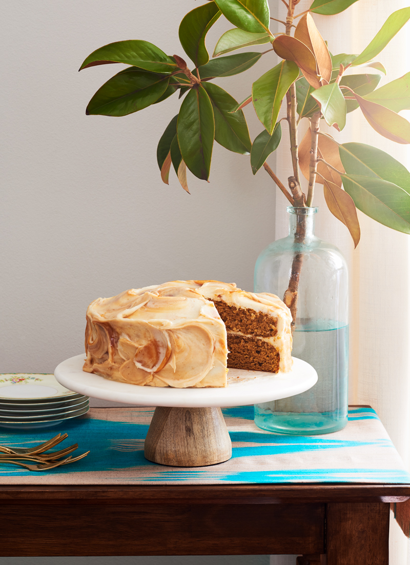 Rum cake on a cake stand near a window with pretty light is food photography by Alison Gootee Photography