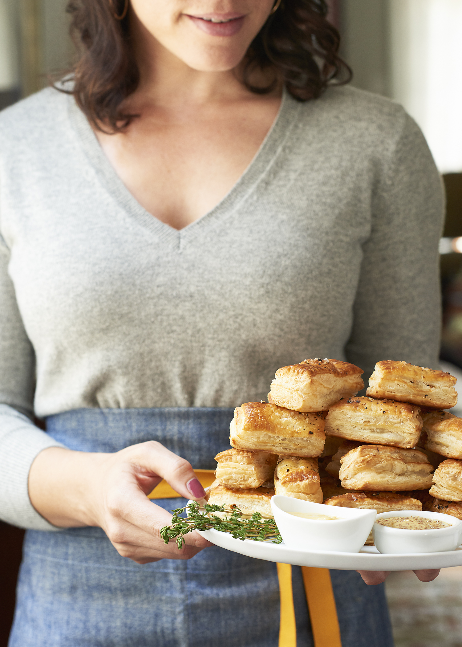 woman holding a stack of warm biscuits is food photography by Alison Gootee Photography