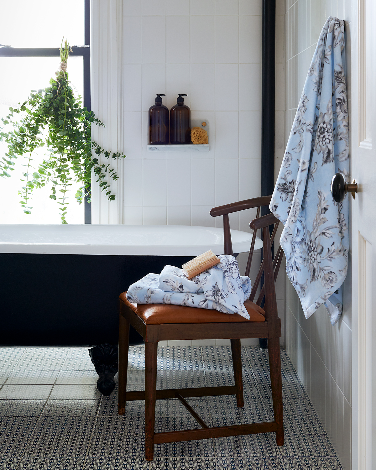 Claw foot tub with plants and towels by Alison Gootee Photography