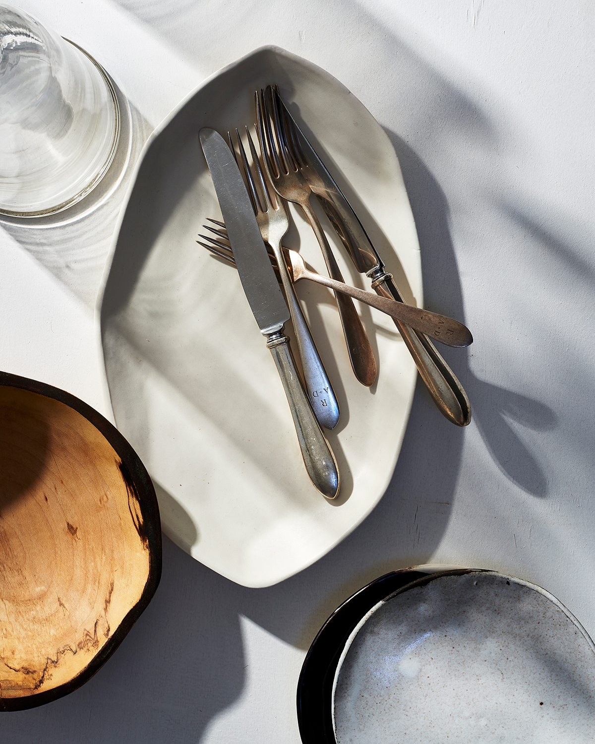 Serving dishes plates and utensils in shadows  Still-life by Alison Gootee Photography