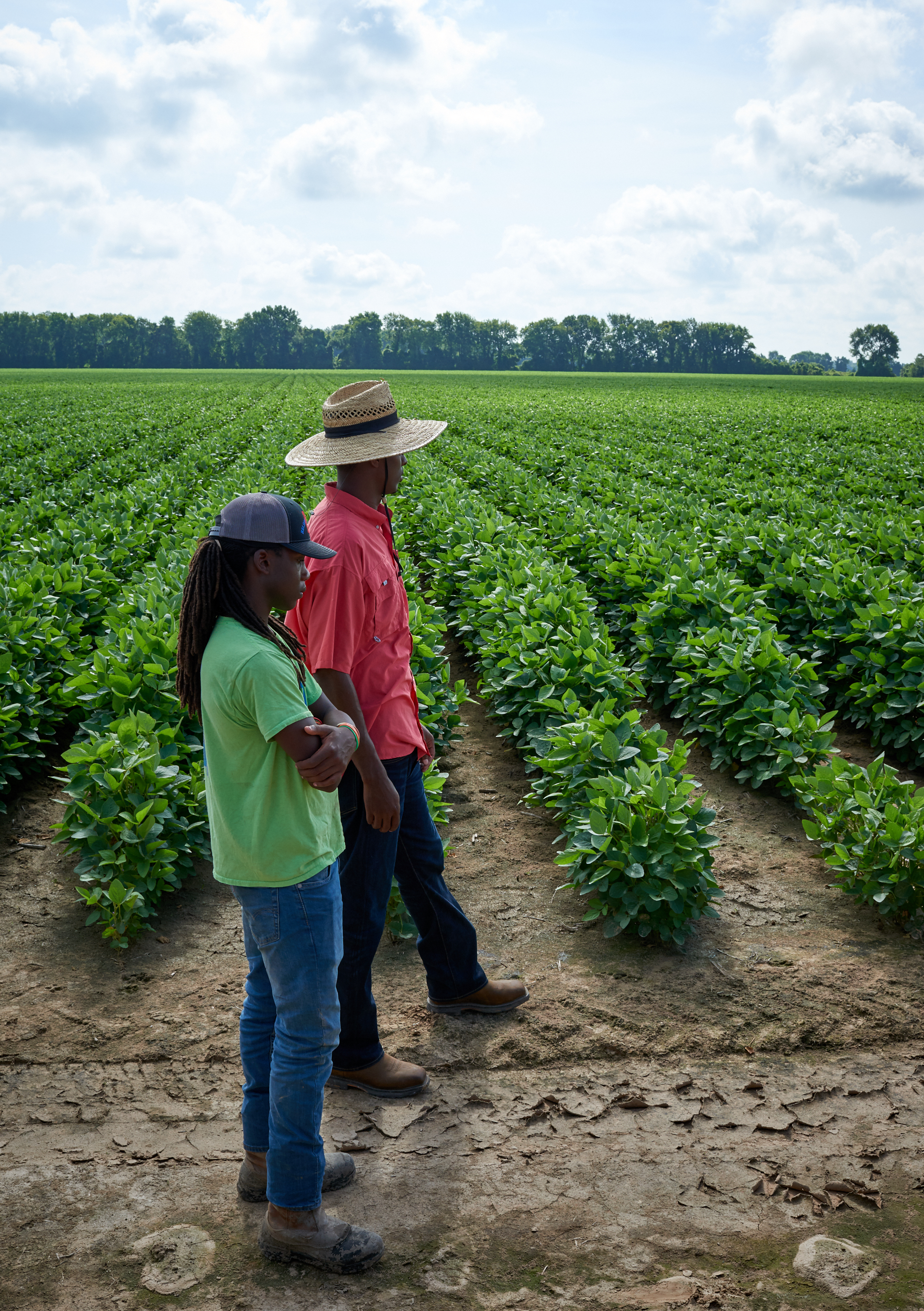Black Farmers standing on the edge of soybean field by Alison Gootee Photography