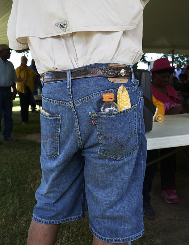 Black Farmer with corn cob in back pocket by Alison Gootee Photography