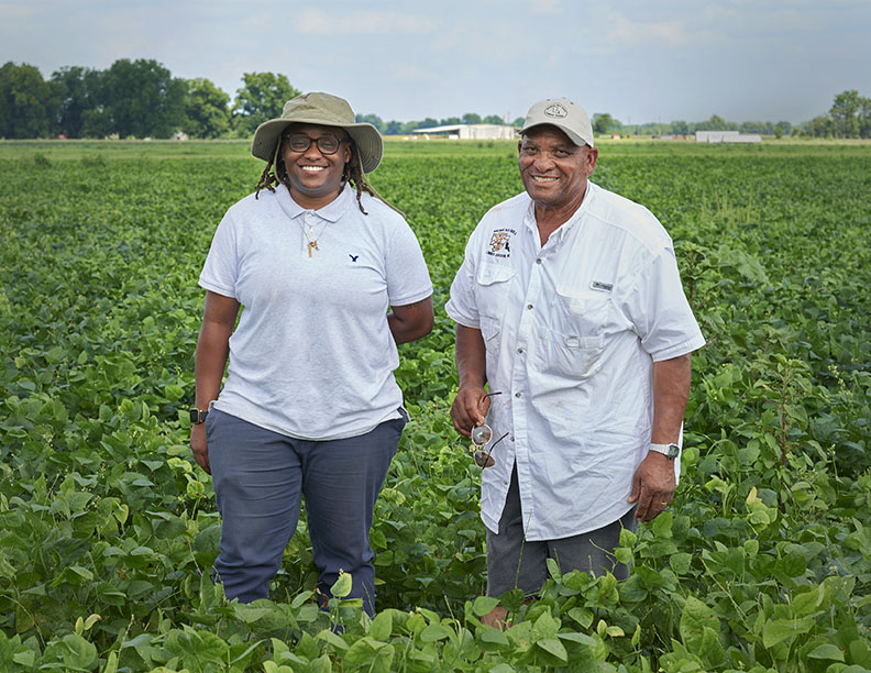Father and daughter Black Farmers in a field by Alison Gootee Photography