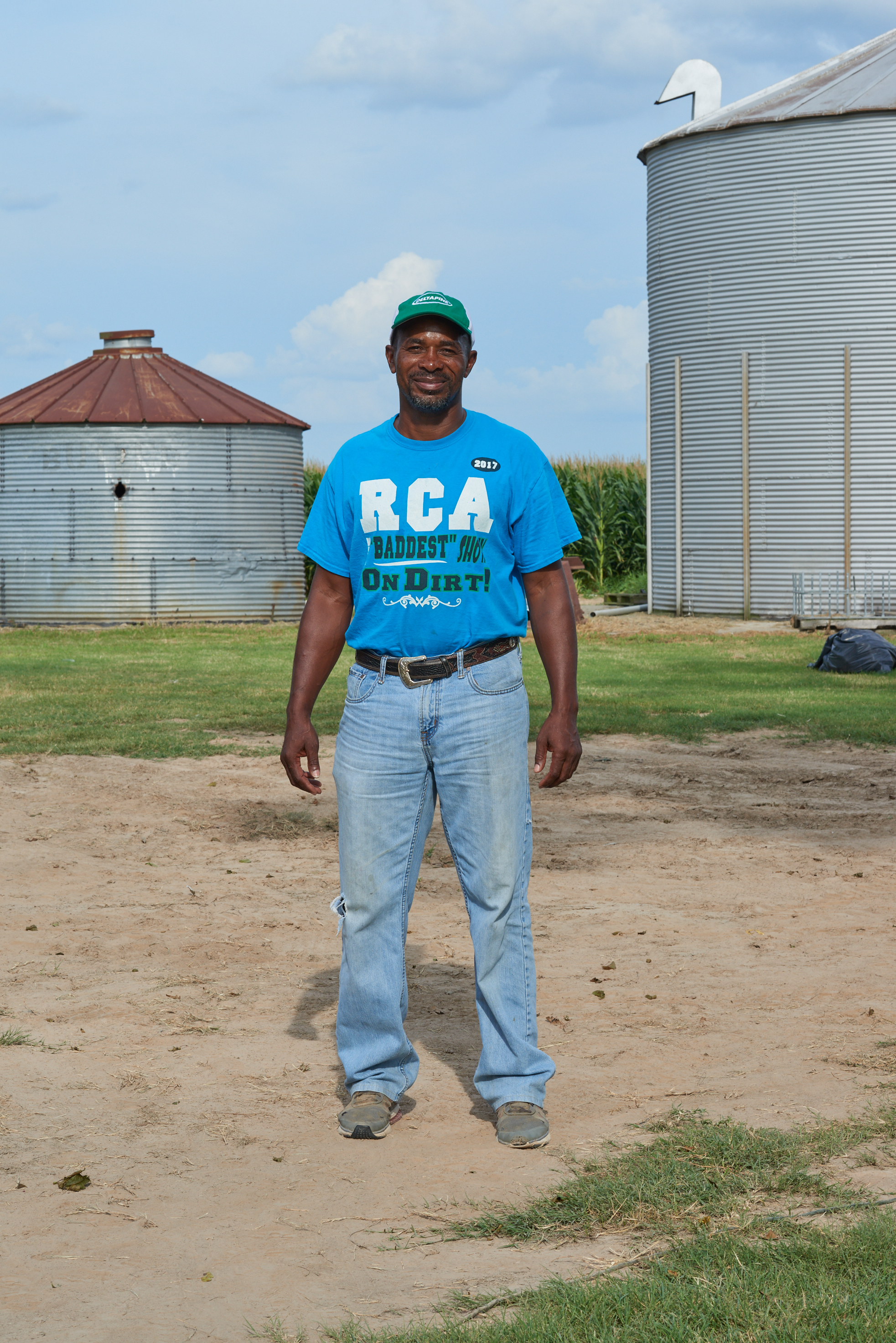 portrait of Black Farmerin front of grain silo by Alison Gootee Photography