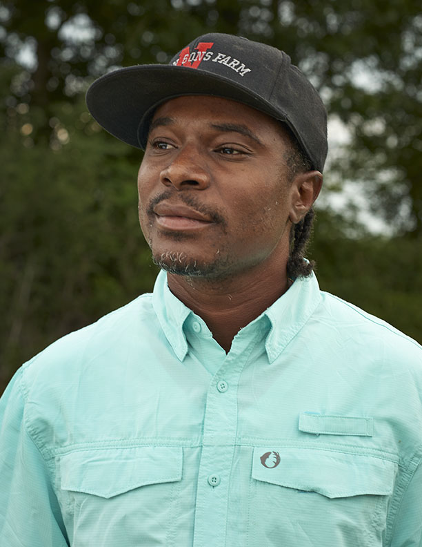 Black Farmer in braids and aqua shirt by Alison Gootee Photography
