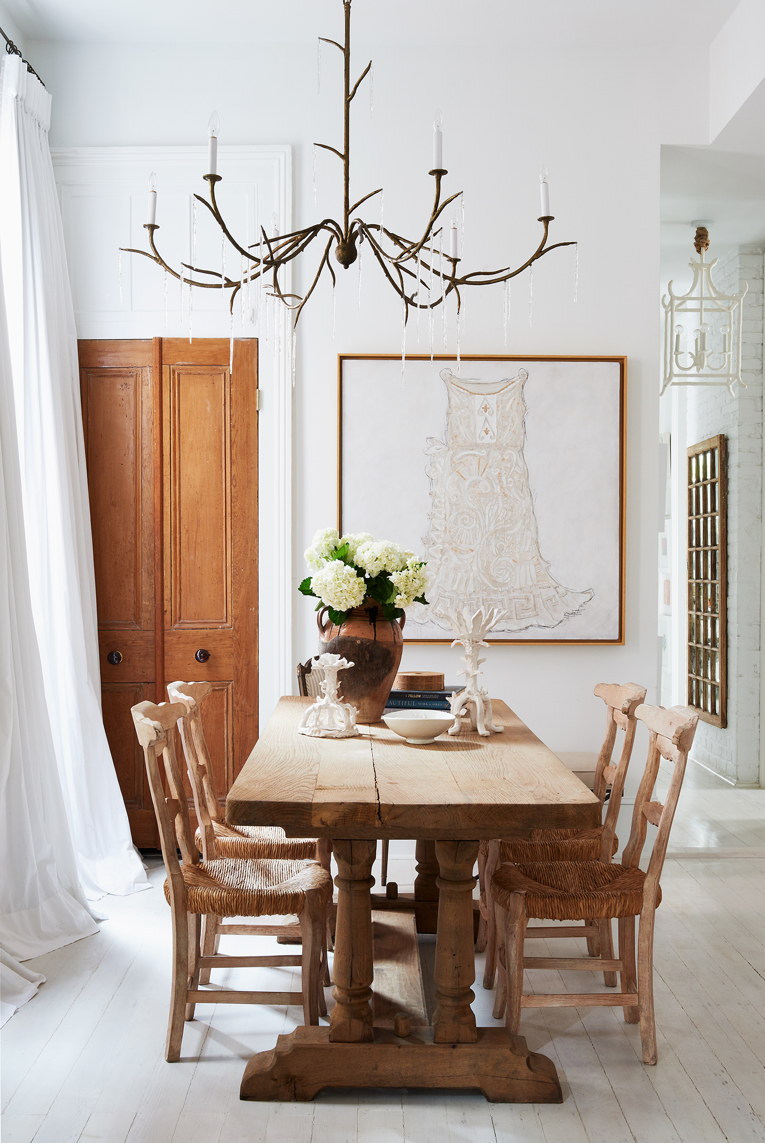 Julie Neill chandelier and her origianl artwork in the New Orleans home of Julie Neill in Garden and Gun Magazine by Alison Gootee photography