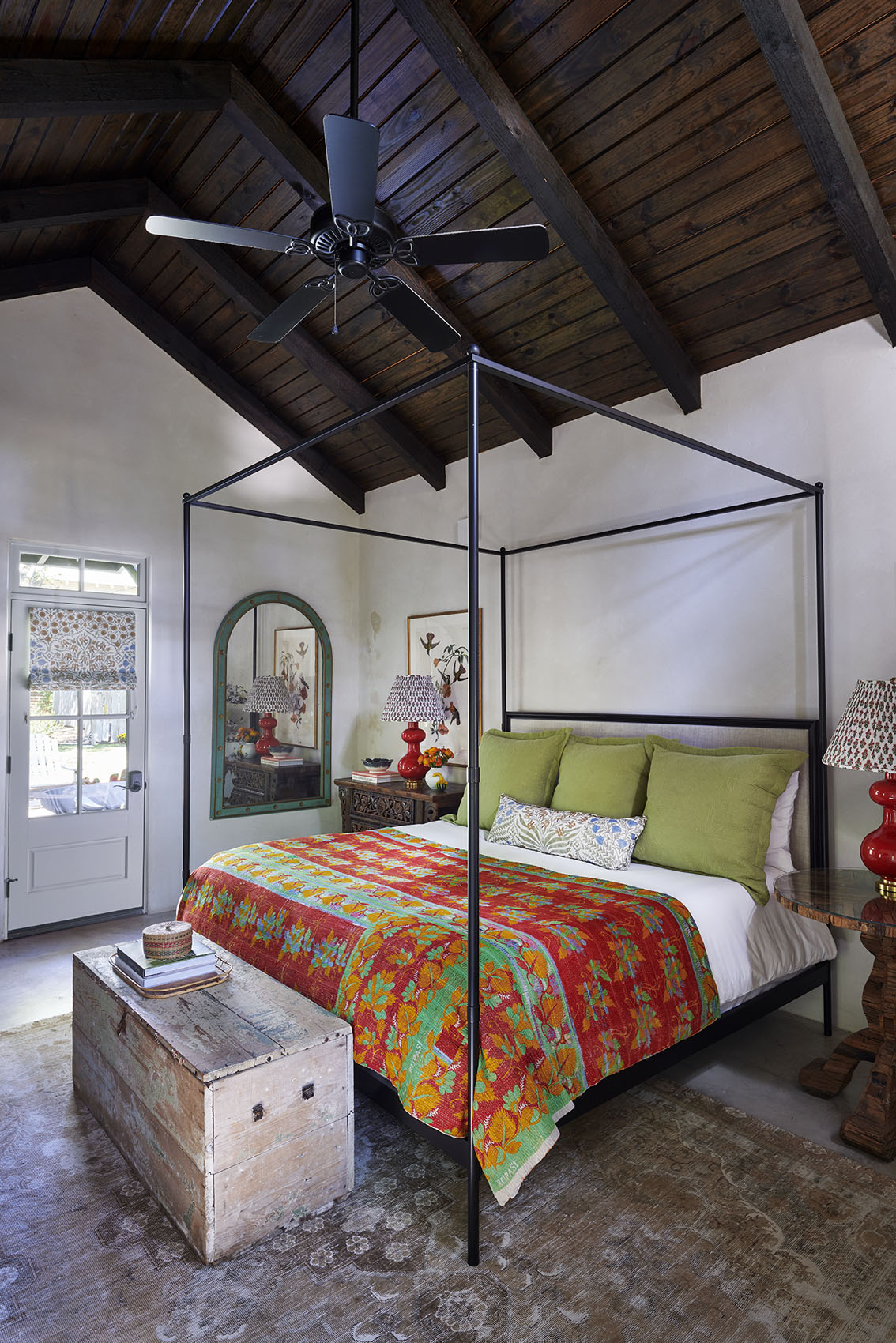 Bedroom with 4 poster bed with red coverlet and vaulted ceiling  in Southern Living Magazine in Fredericksburg Texas by Alison Gootee Photography