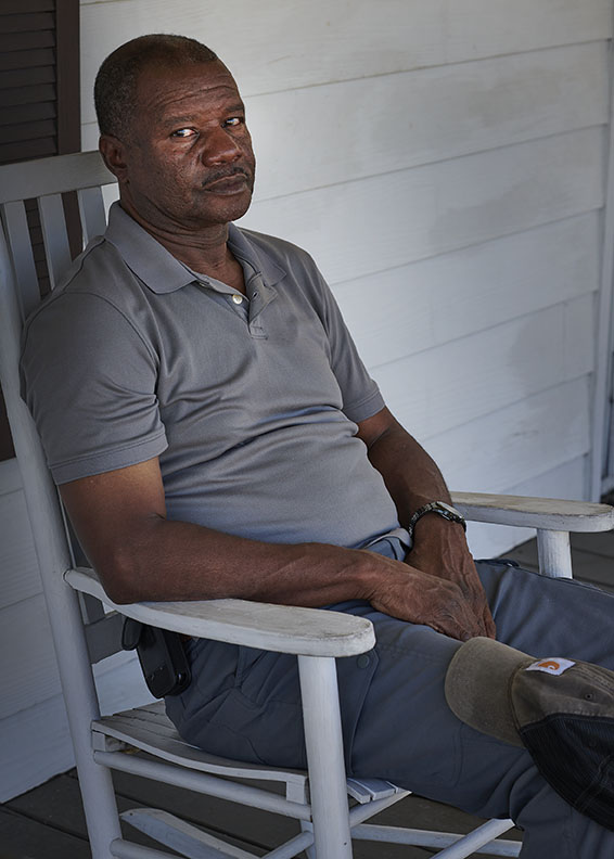 Black Farmer in rocking chair by Alison Gootee Photography