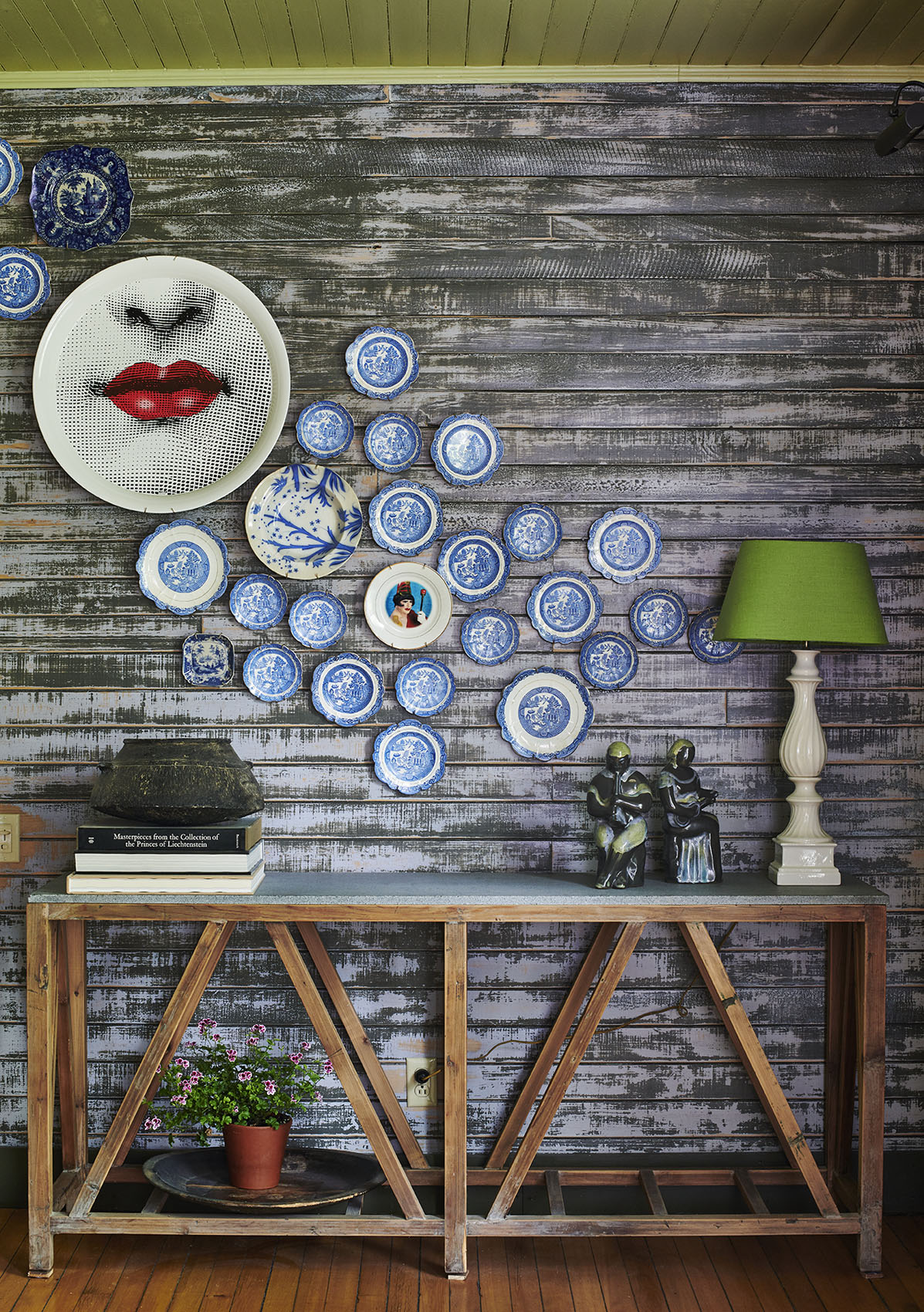 fornasetti plates on wall in MartinBourne Home by Alison Gootee Photography