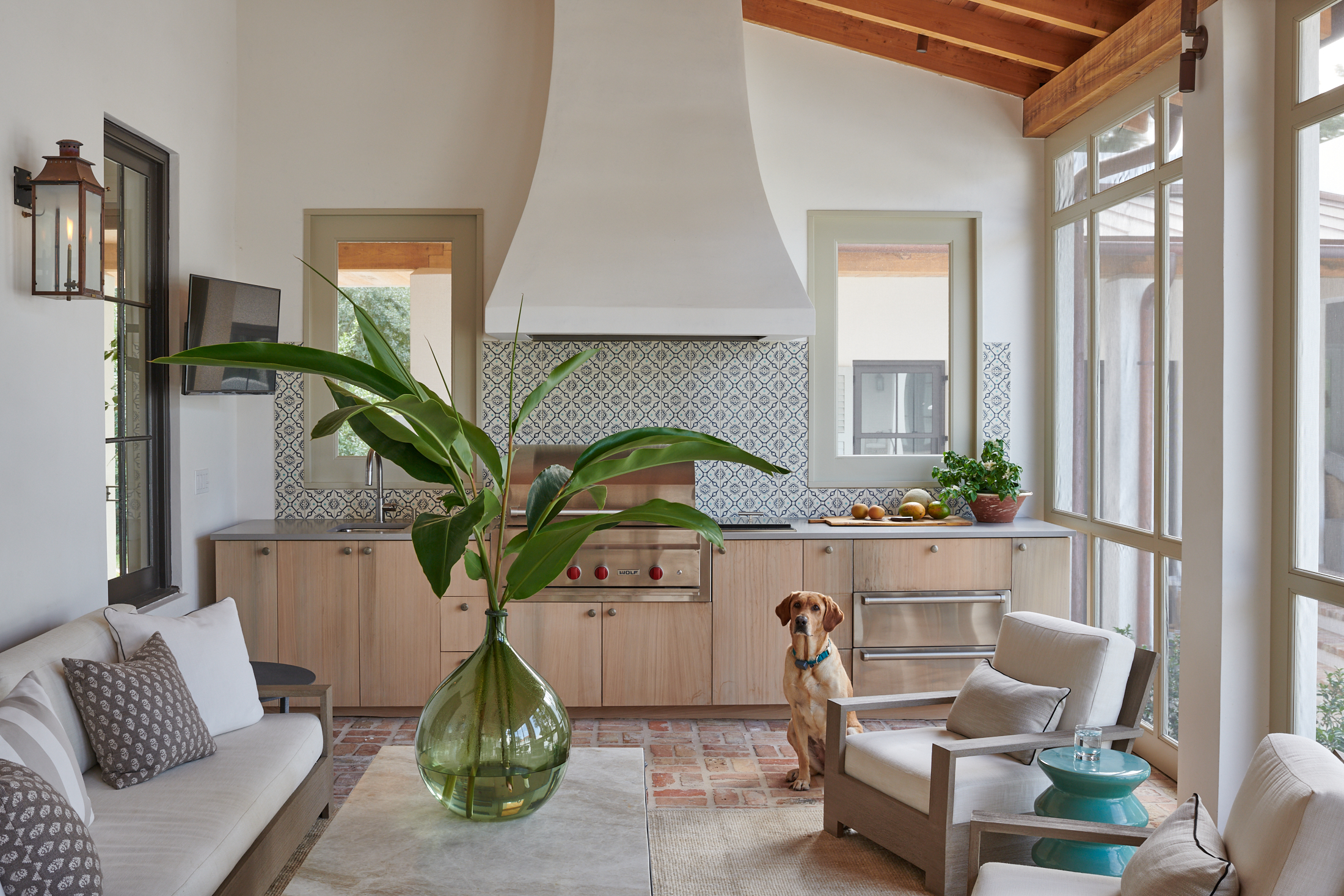 Screened in porch with grill top and dog by Alison Gootee Photography for Logan Killen Interiors 