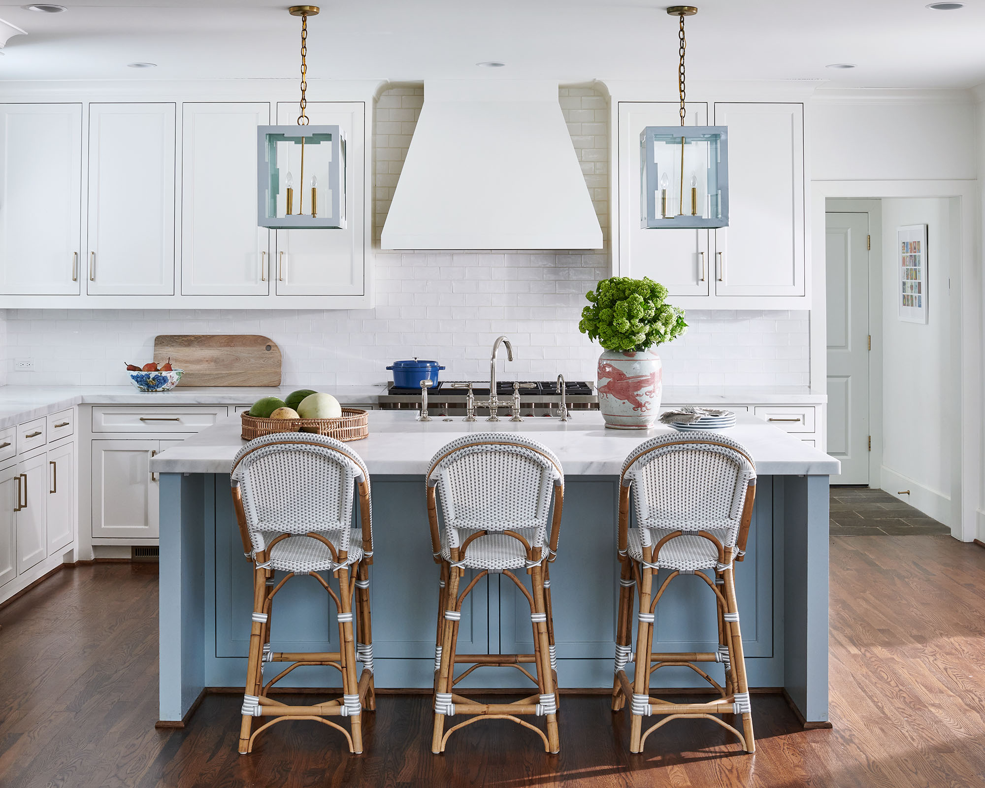 White kitchen island with woven seats Blue seating area by Madre design in Southern Living Magazine in Dallas Texas by Alison Gootee Photography
