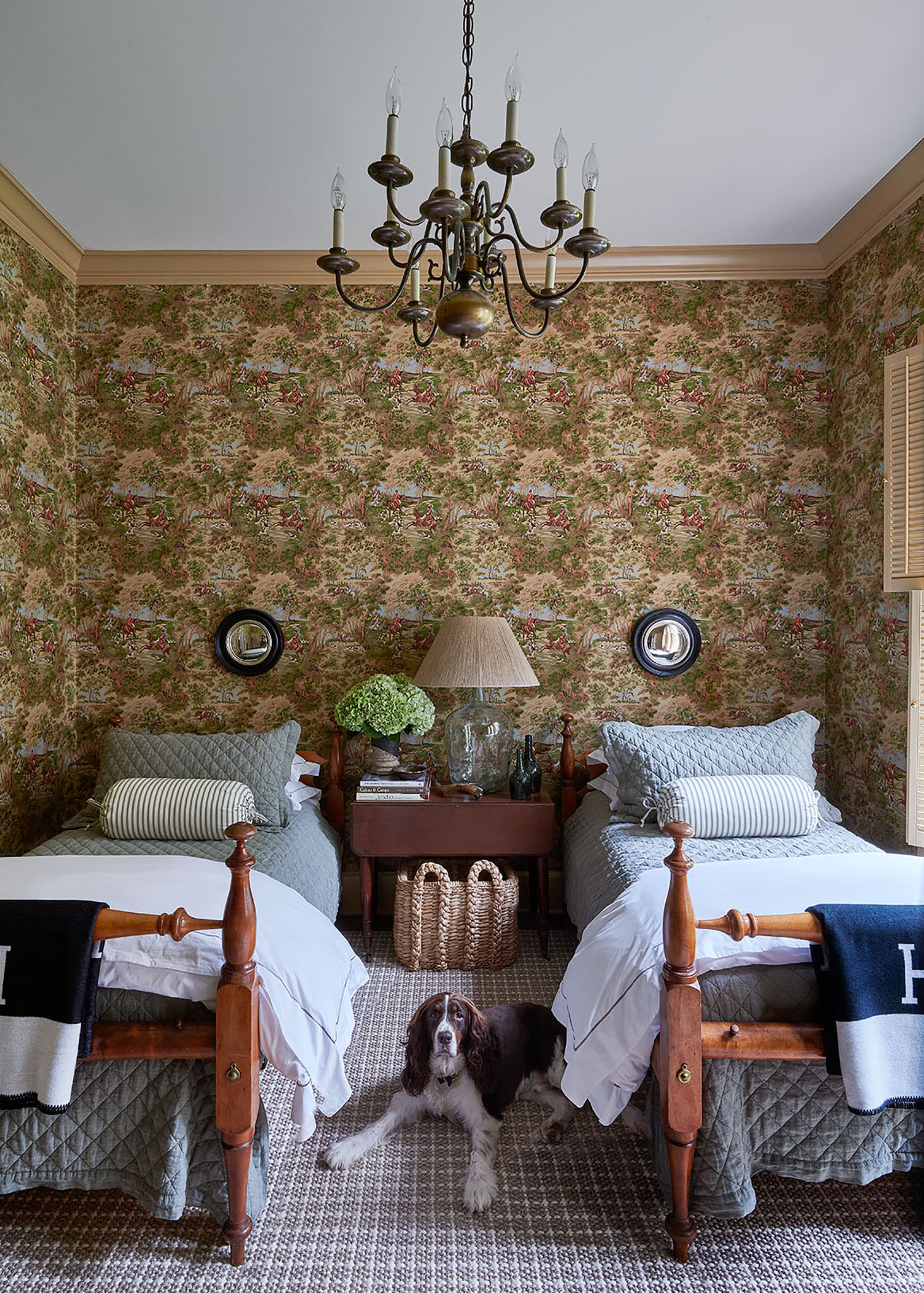 Twin beds in bedroom with vintage wall paper and a cute dog  in Arkansas Home by Heather Chadduck in Veranda Magazine by Alison Gootee photography