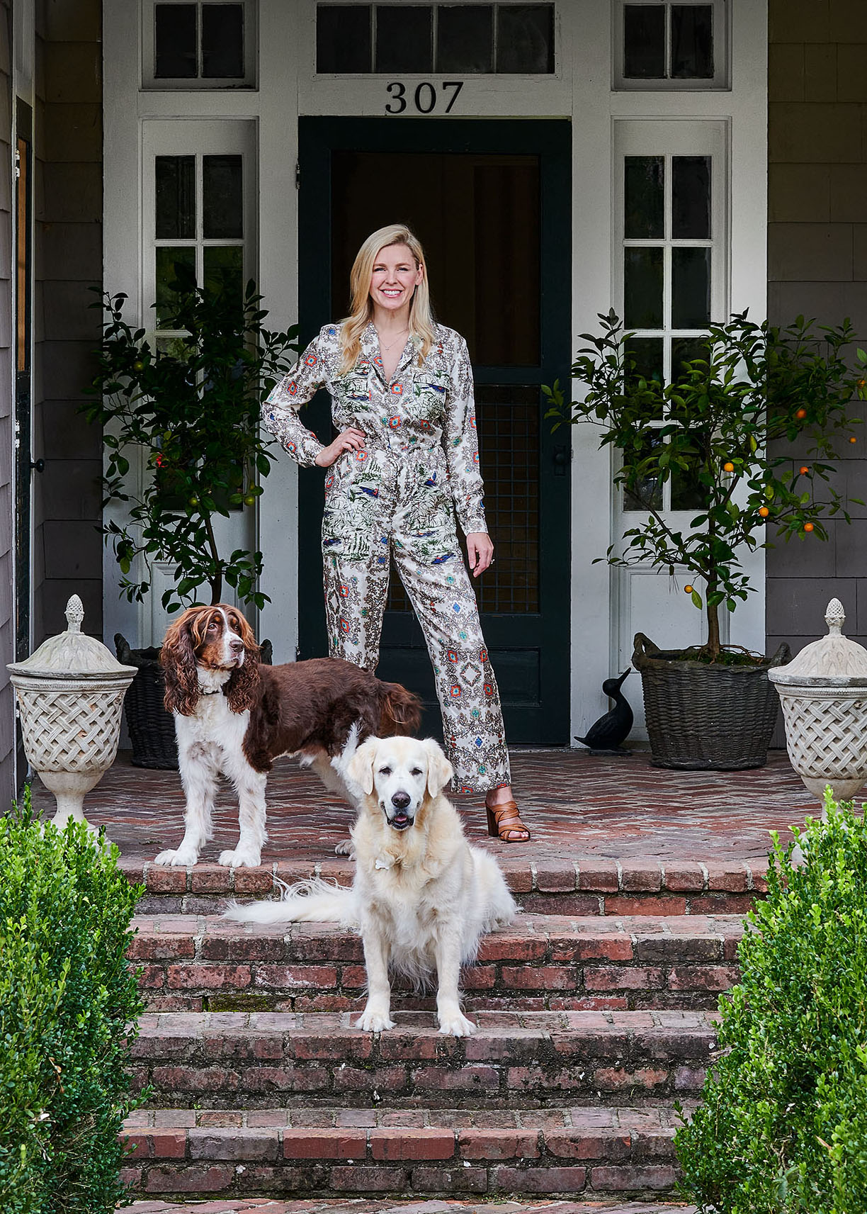 Homeowner on porch with dogs  in Arkansas Home by Heather Chadduck in Veranda Magazine by Alison Gootee photography