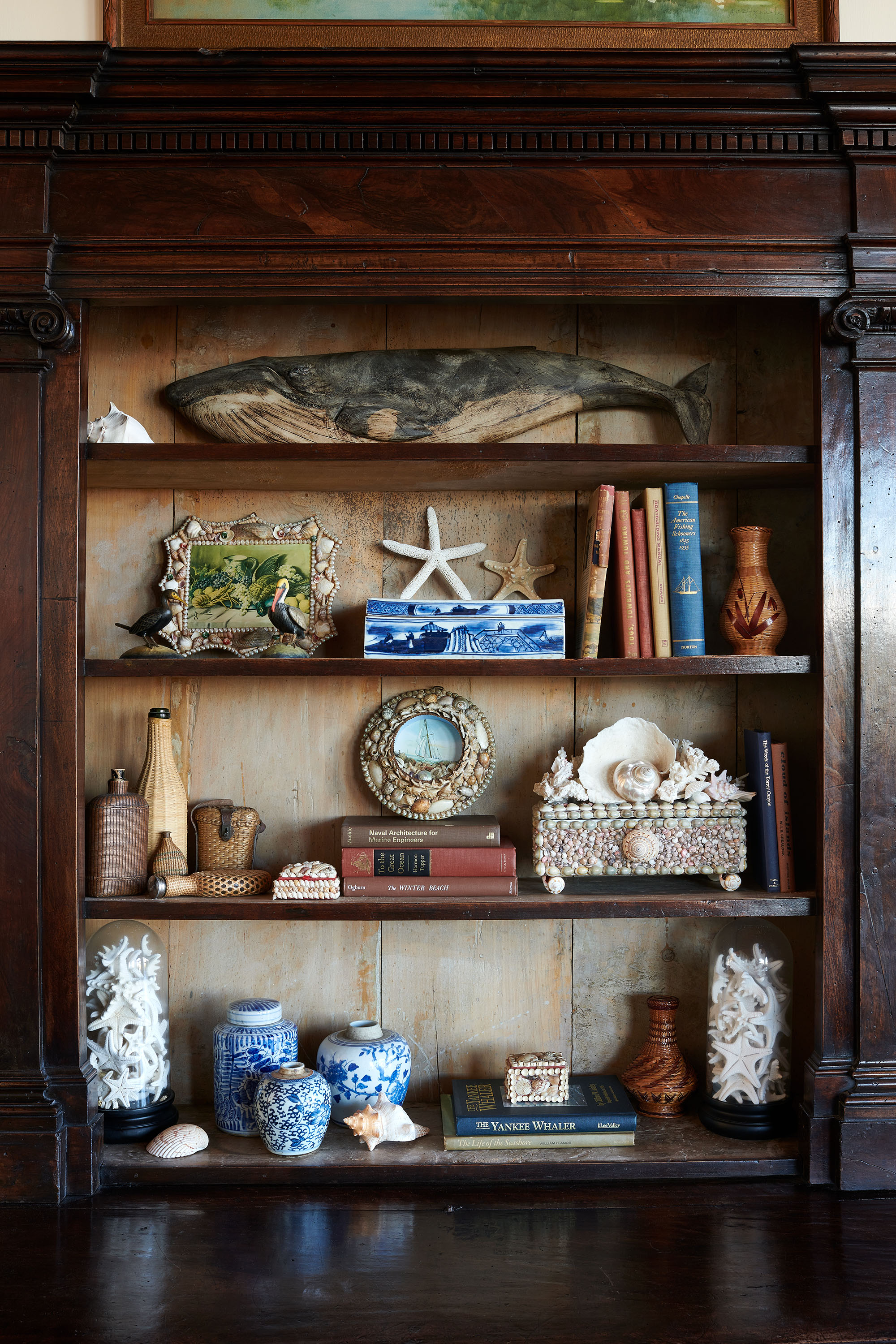 Shelves of nautical antiques in Louisiana Camp by Melissa Rufty in Garden and Gun Magazine by Alison Gootee photography