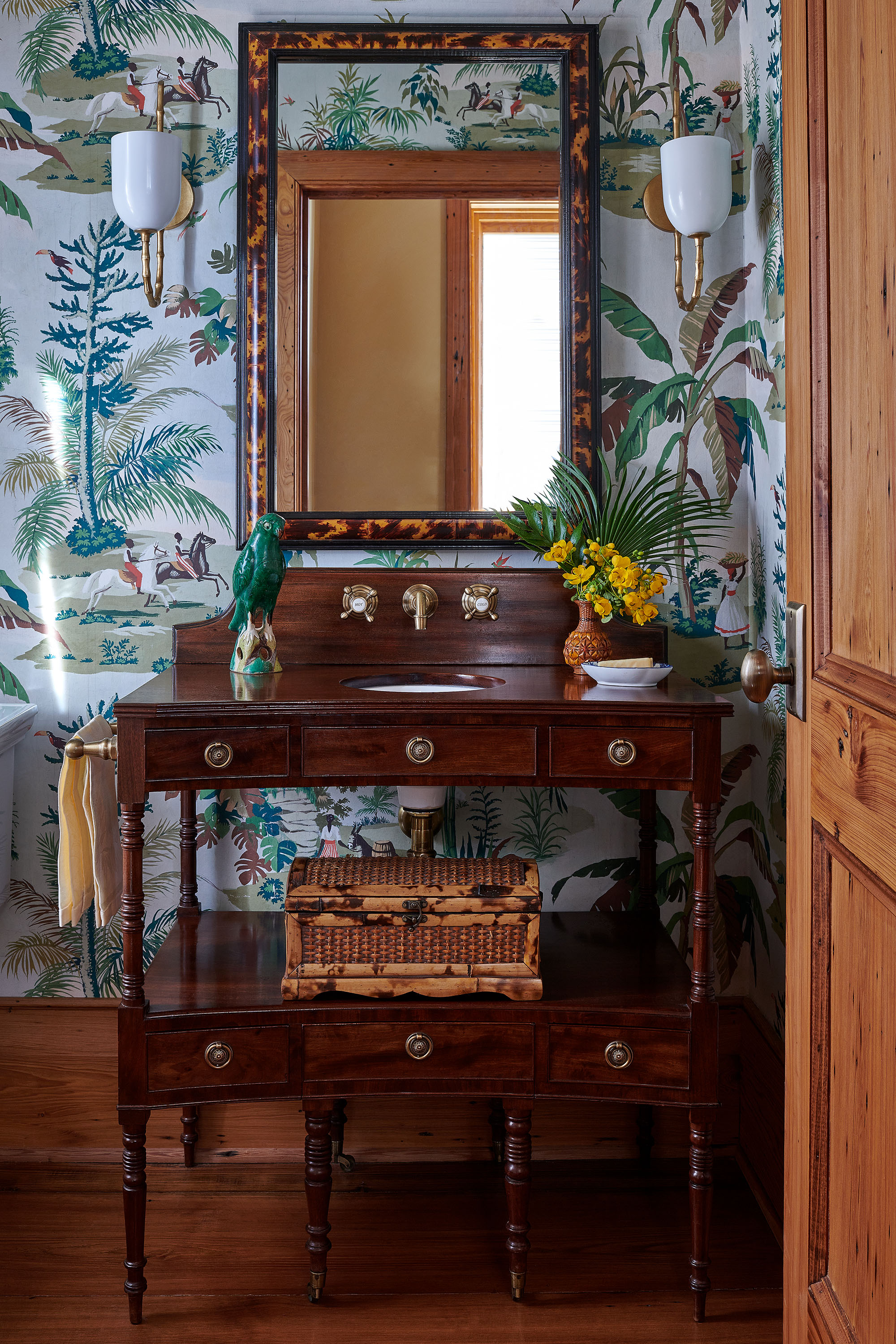 Wallpapered bathroom sink in Louisiana Camp by Melissa Rufty in Garden and Gun Magazine by Alison Gootee photography