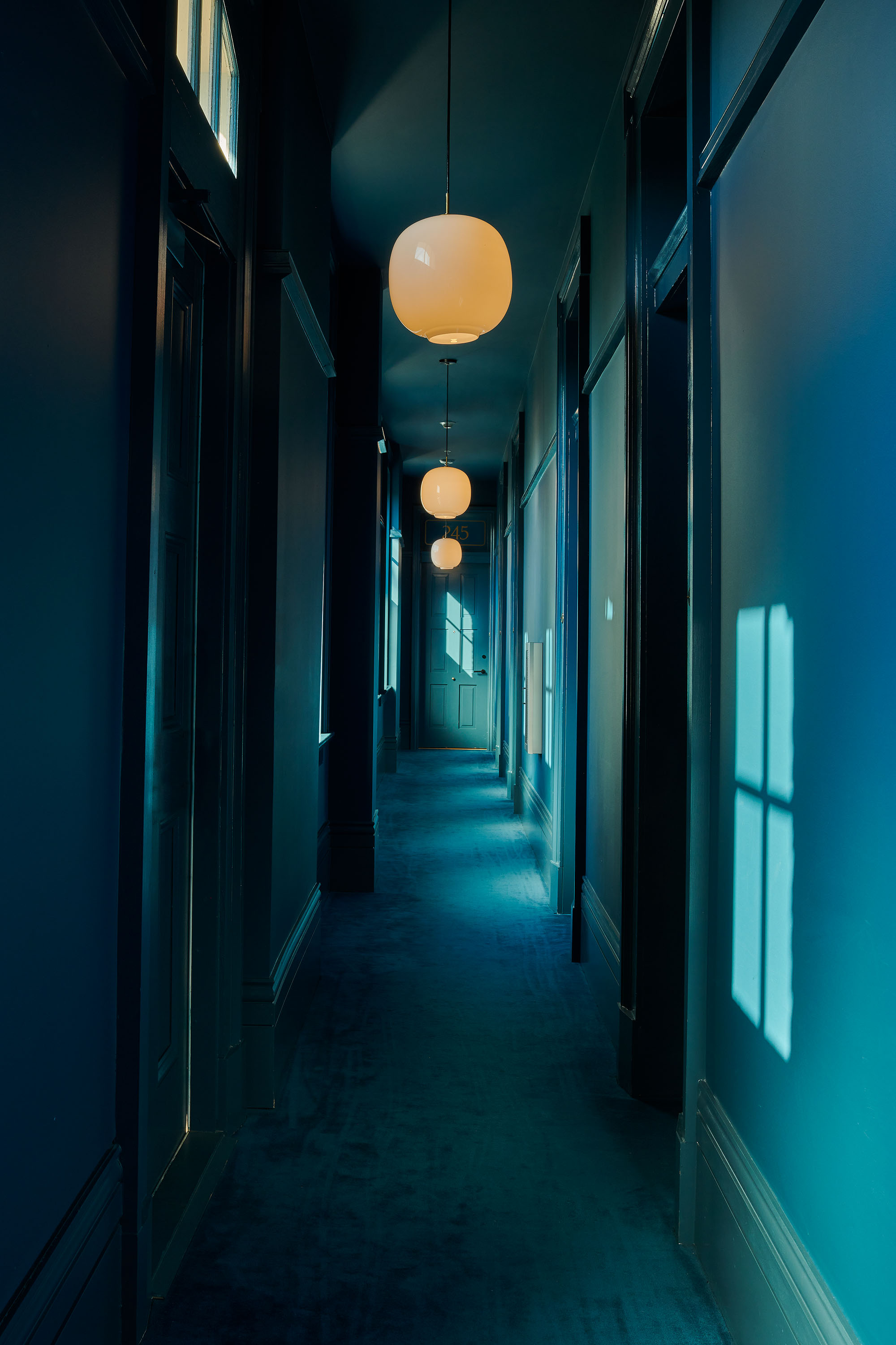 Blue hallway with shadows in Hotel St.Vincent in New Orleans by Alison Gootee photography