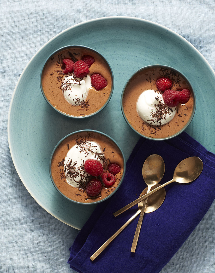 Three small bowls of chocolate mouseon blue plate is food photography by Alison Gootee Photography