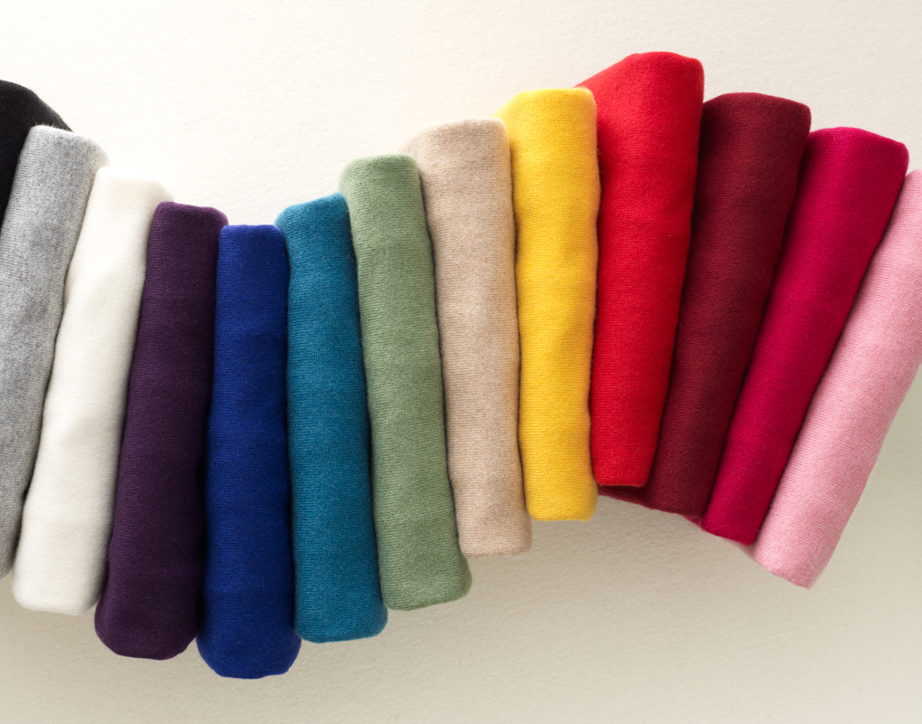 Colorful rainbow Stack of sweaters on white by Alison Gootee Photography 