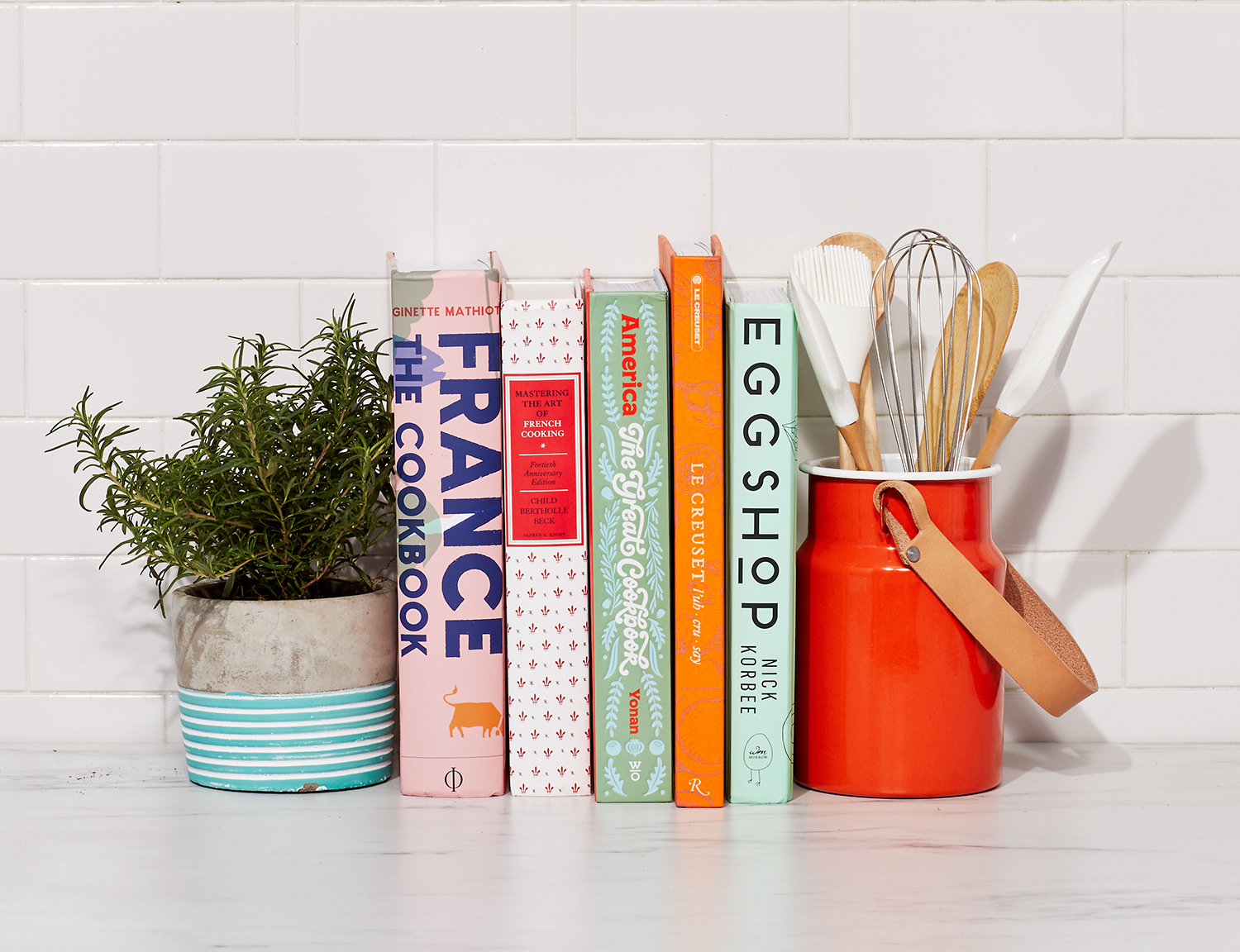 Bright kitchen counter with cookbooks and utensil crock with tile wall  Still-life by Alison Gootee Photography