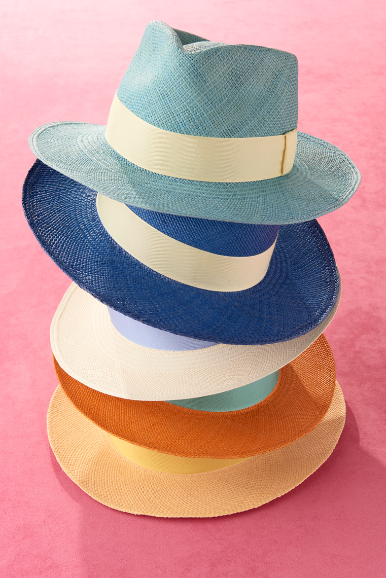 Fashion Still-life of colorful straw hatson pink background by Alison Gootee Photography 