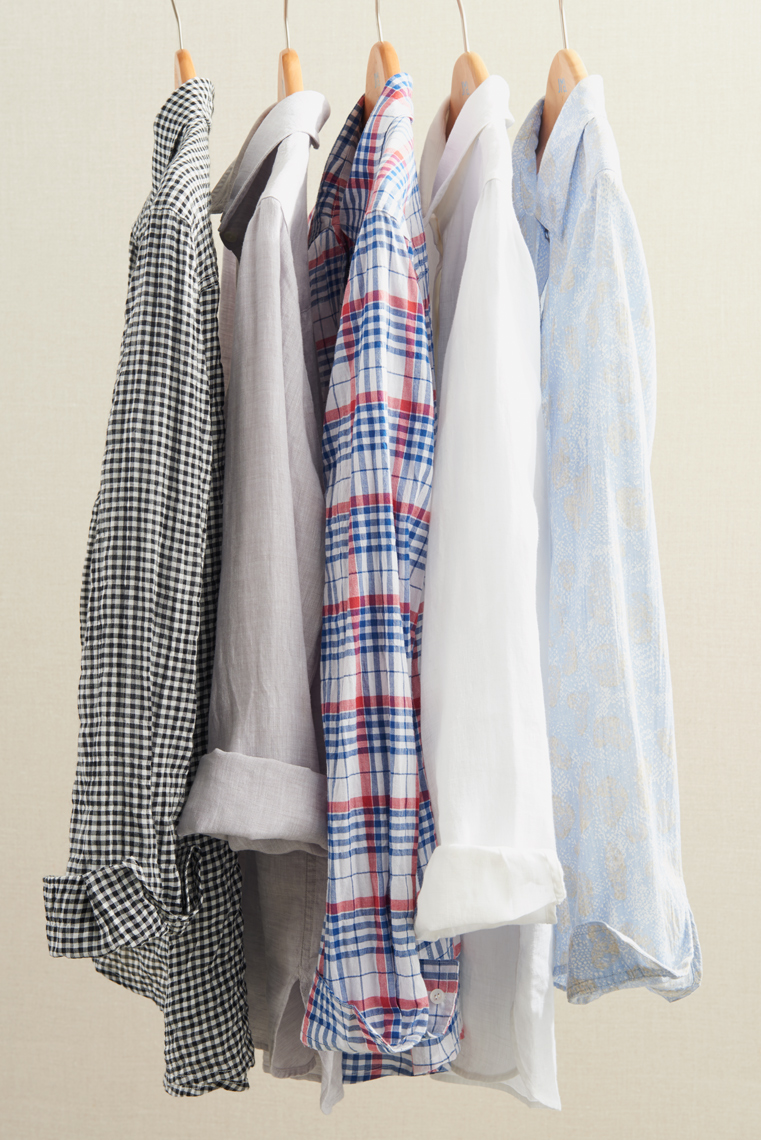 Group of colored patterned shirts on hangers by Alison Gootee Photography 