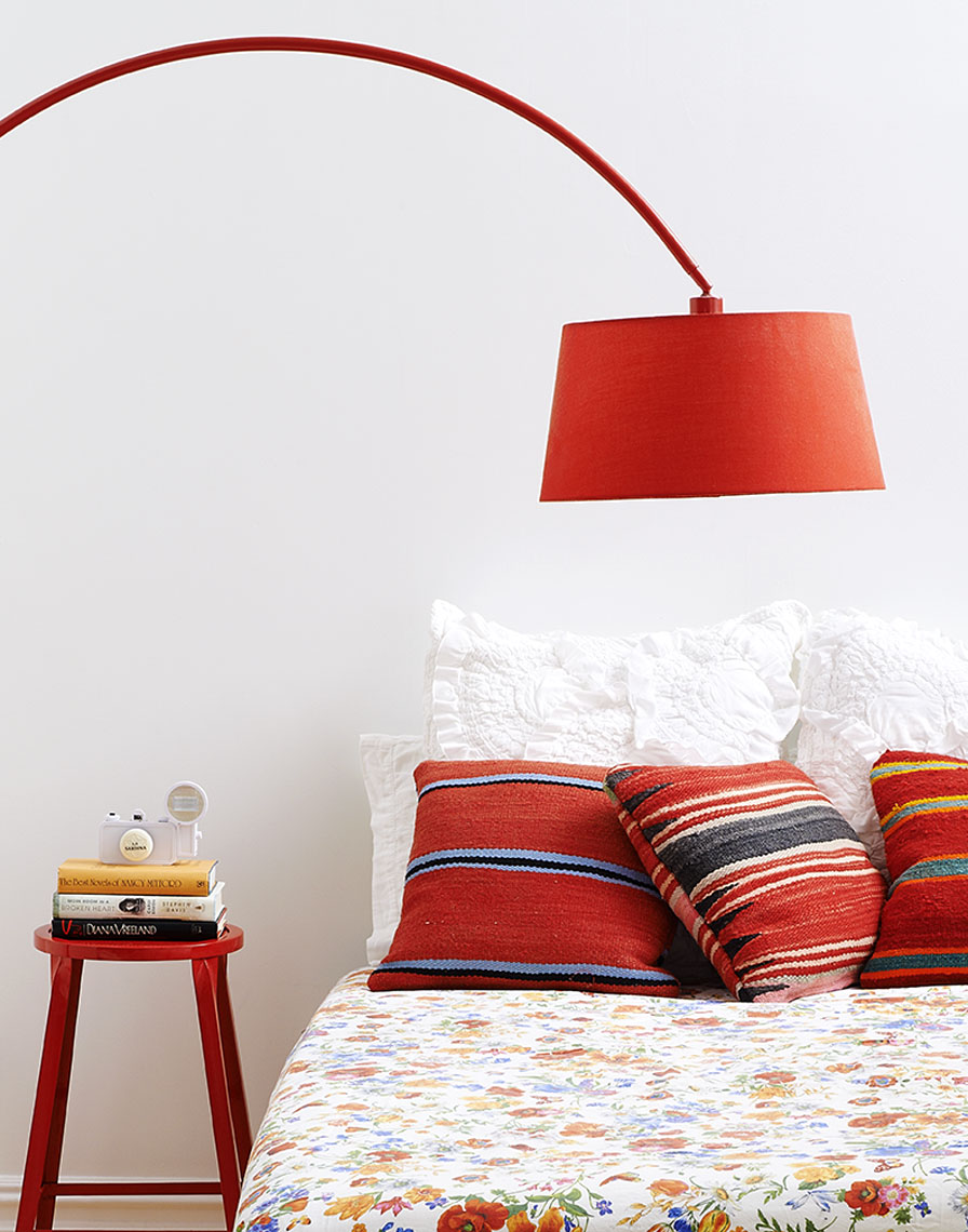 Red lamp hanging over bed by Alison Gootee Photography