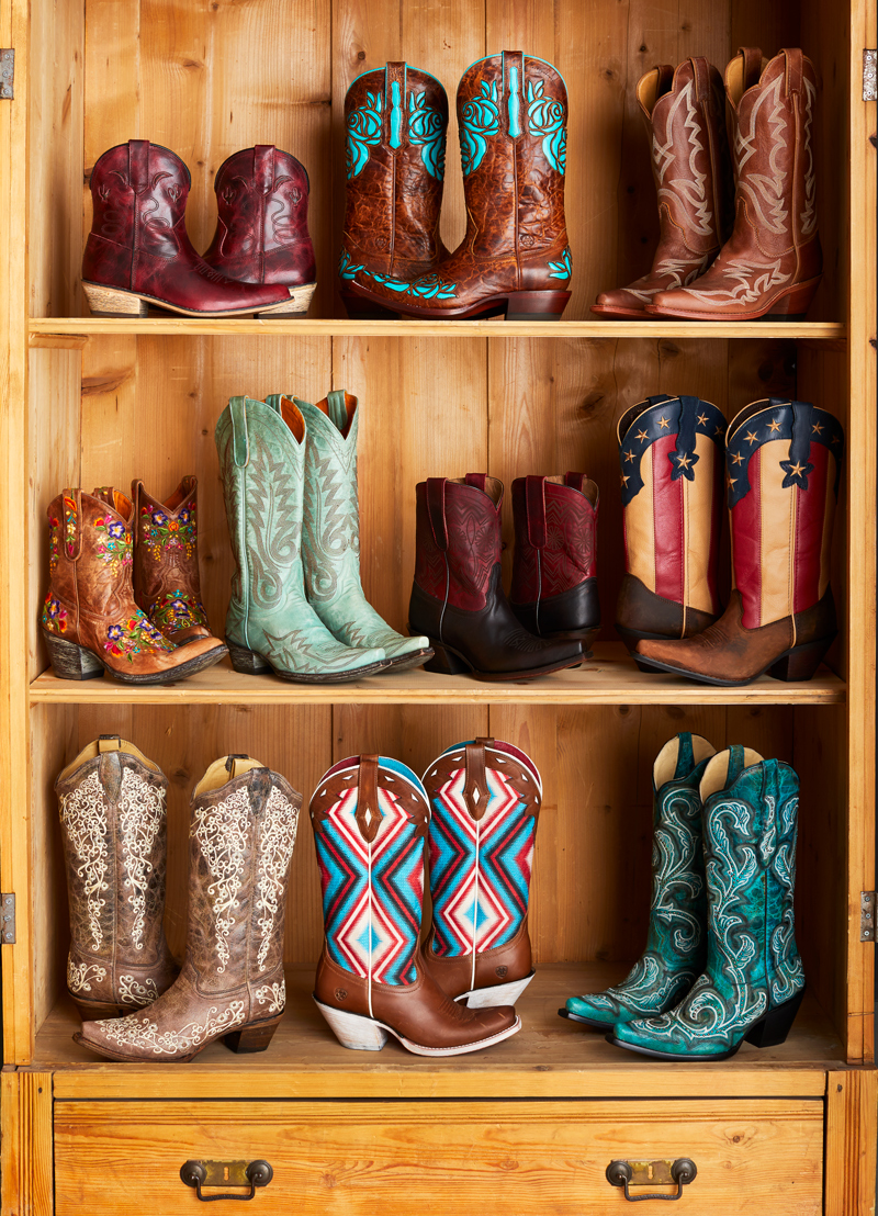 Group of colorful cowboy boots on wooden shelves Still-life by Alison Gootee Photography
