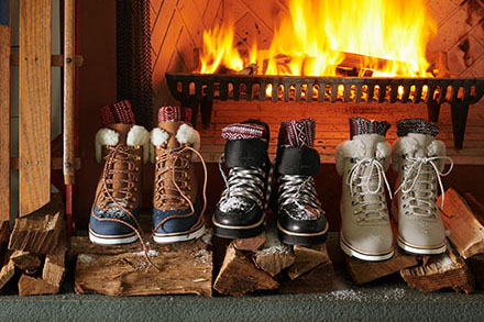 Snow boots in front of fire by Alison Gootee Photography 
