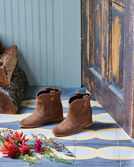 Boots on a tile floor by Alison Gootee Photography 