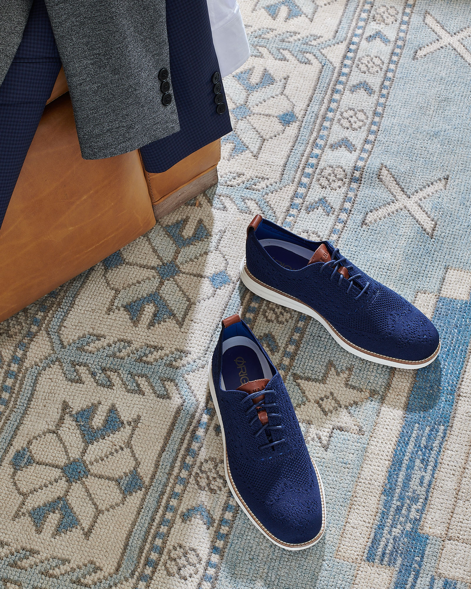Blue sneakers on light blue rug by  Alison Gootee Photography
