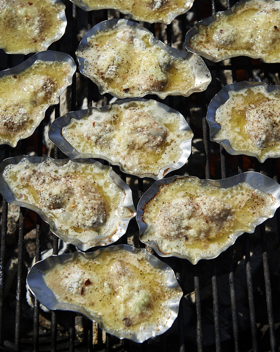 Louisiana oyster being charbroiled on grill is food photography by Alison Gootee Photography