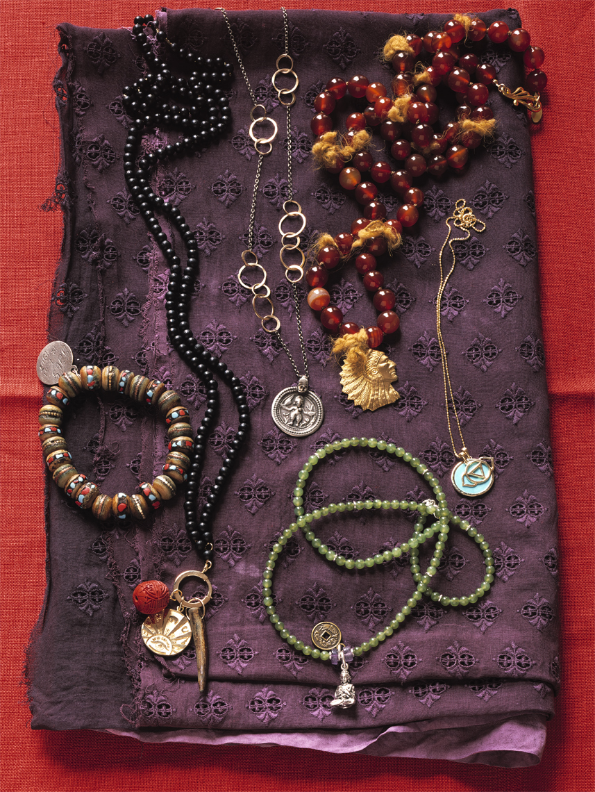 Jewerly and charms on pieces of purple fabric by Alison Gootee Photography 