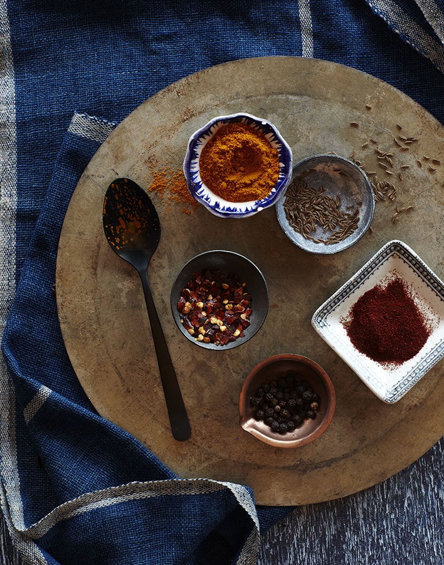 moody ground spices on copper tray with tiny dishes is food photography by Alison Gootee Photography